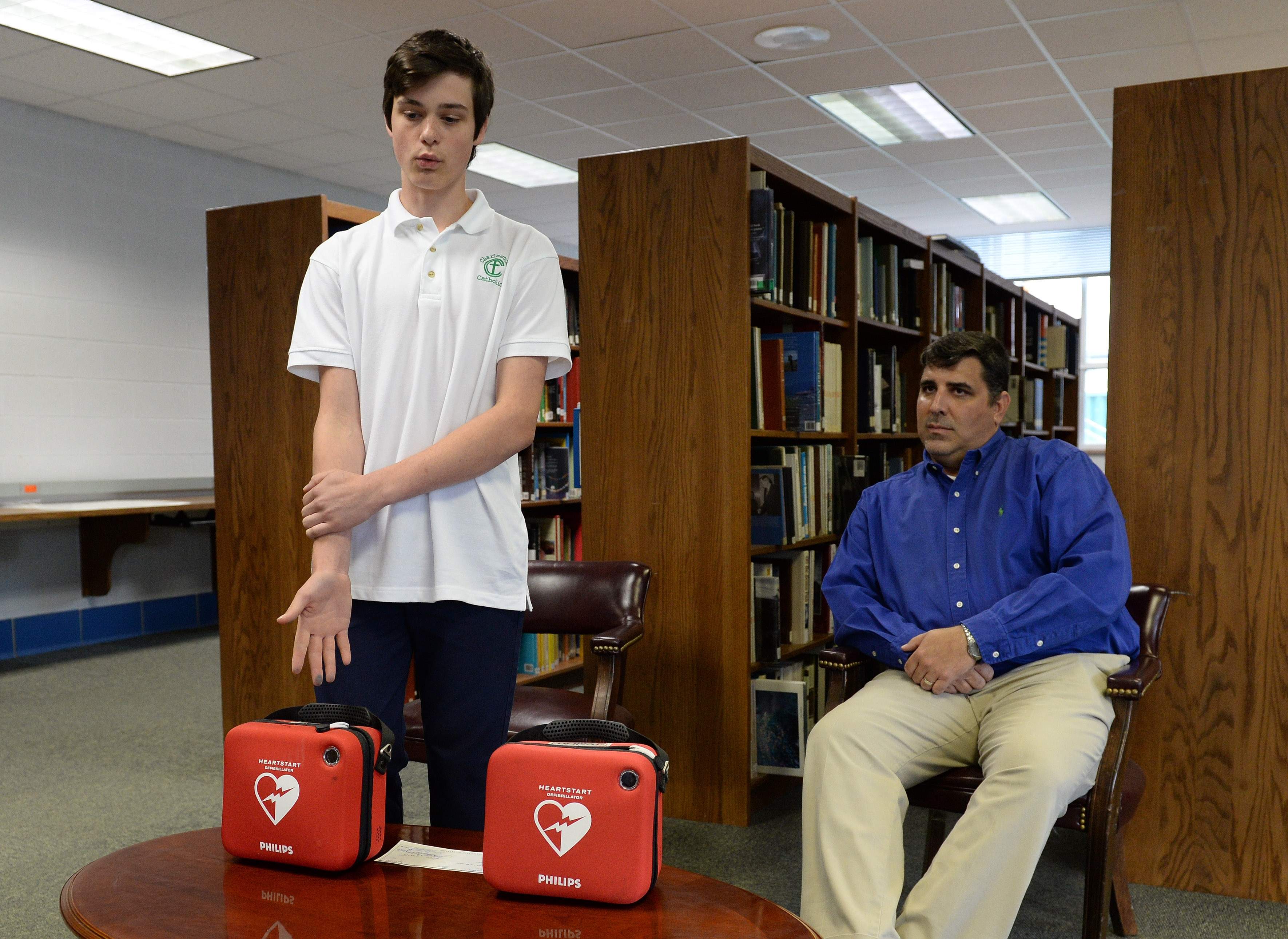 Charleston Catholic student donates automated external defibrillators to school 